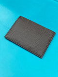 Small cardholder in brown pebbled vegan leather. 2 card slots on each side and slot in middle. 