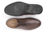 Overhead shot of shoe with cork insole and Ahimsa logo inside, and bottom of shoe black sole.