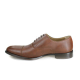 A tan vegan leather men's dress shoe with a cap toe. Slightly tapered toe. Lace up with 5 eyelets. Beige lining and brown sole.
